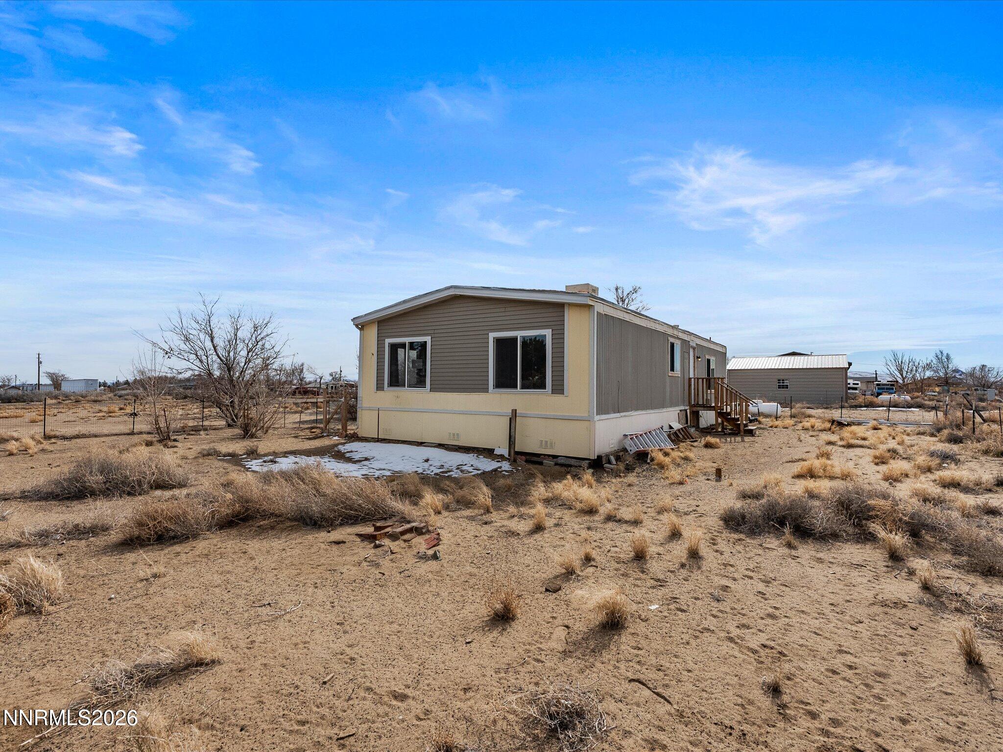 7815 Springfield Road Silver Springs, NV 89429 - Photo 27 of 46 a view of a house with a backyard