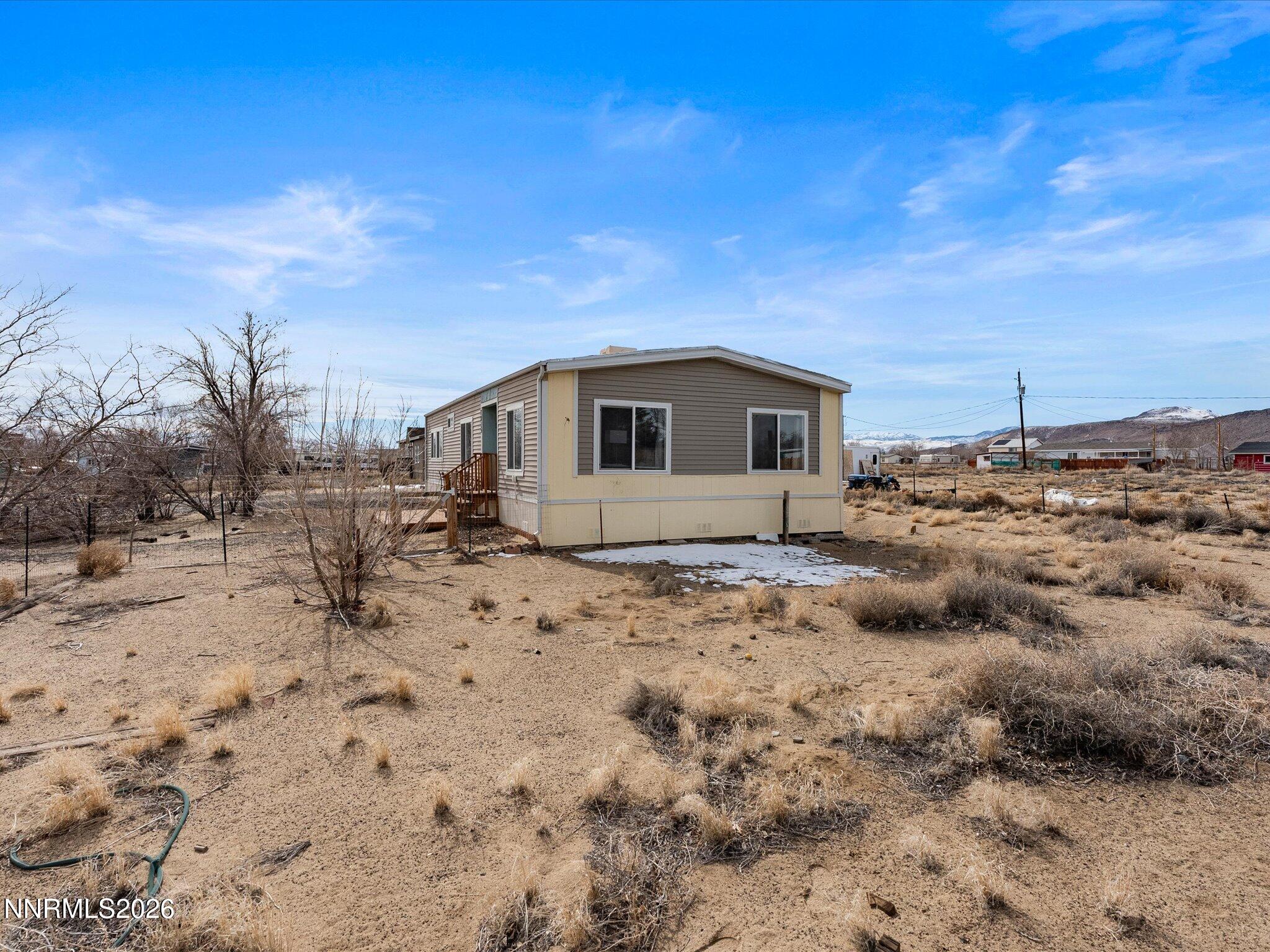 7815 Springfield Road Silver Springs, NV 89429 - Photo 28 of 46 a view of a dry yard with wooden fence