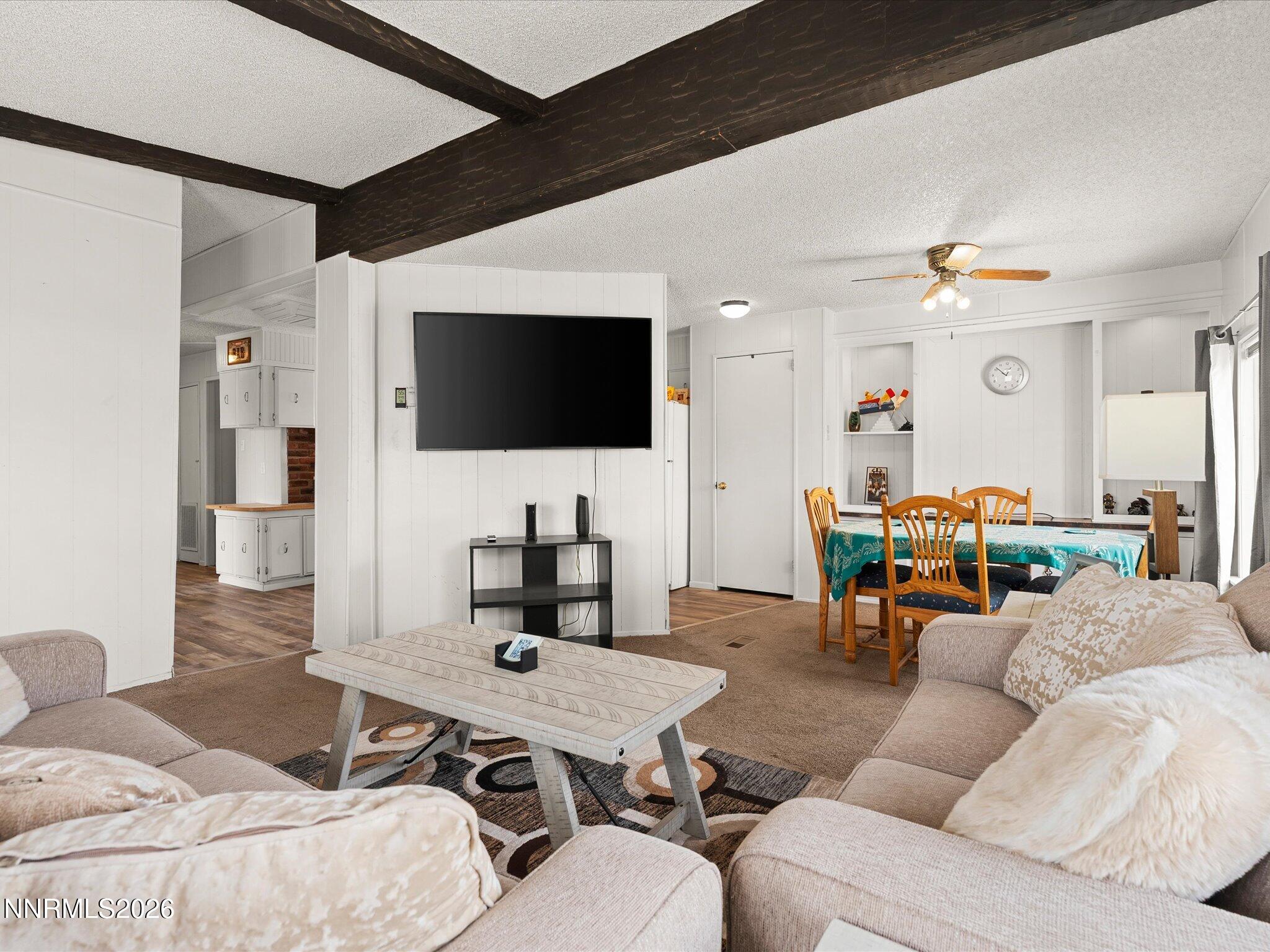 7815 Springfield Road Silver Springs, NV 89429 - Photo 7 of 46 a living room with furniture and a flat screen tv