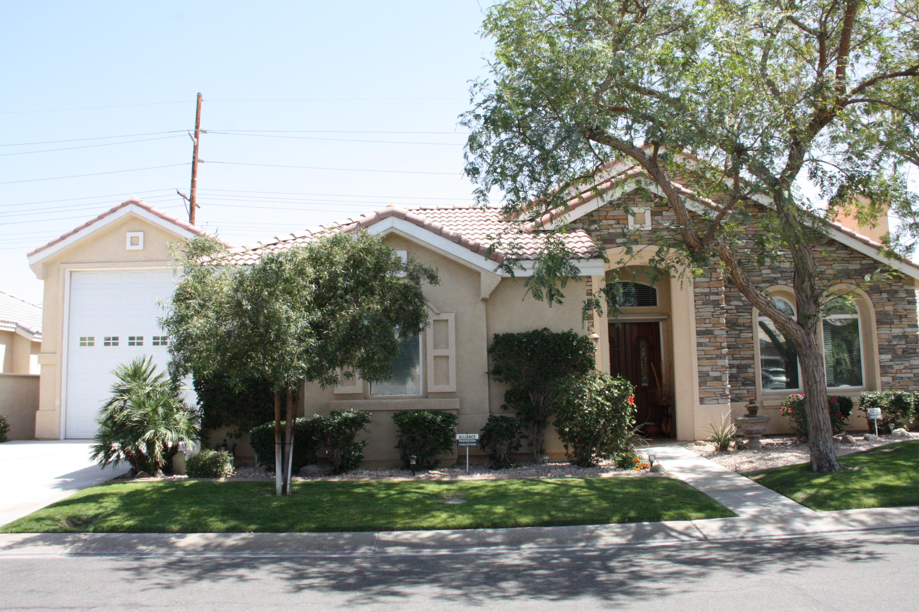 49758 Lewis Road Indio, CA 92201 - Photo 1 of 47 a front view of a house with garden