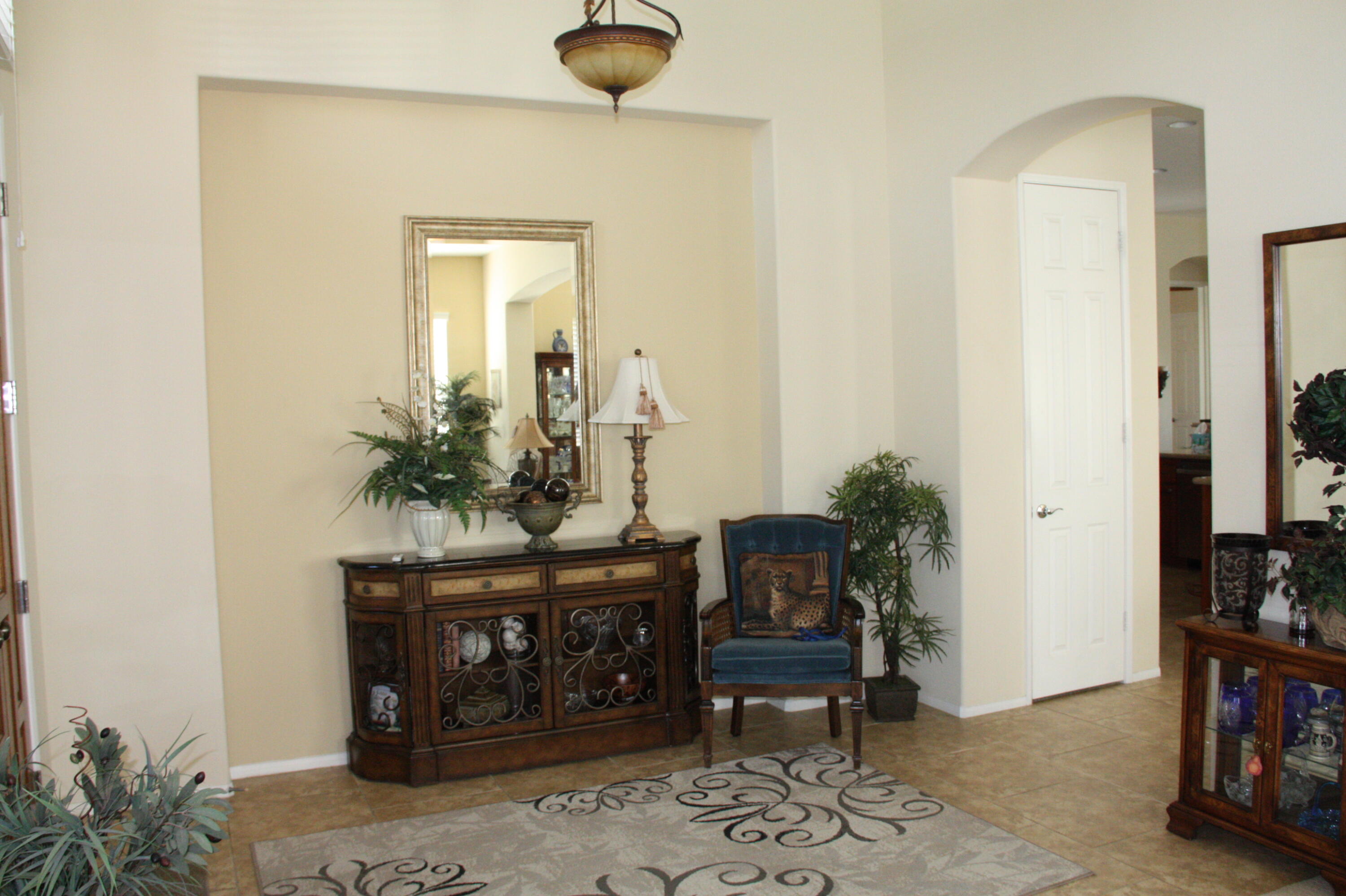 49758 Lewis Road Indio, CA 92201 - Photo 11 of 47 a living room with furniture and a potted plant