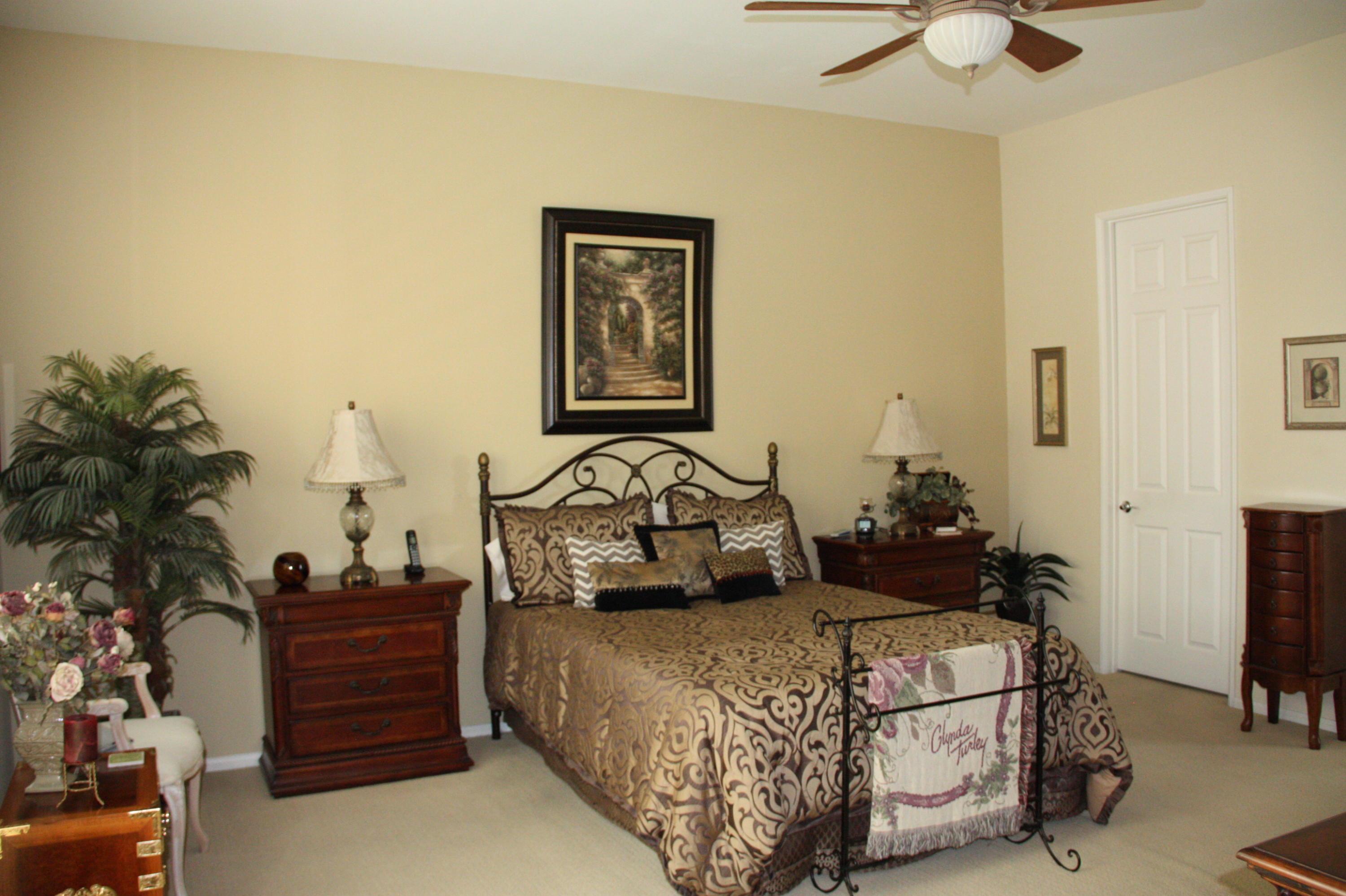 49758 Lewis Road Indio, CA 92201 - Photo 29 of 47 a bedroom with bed and a chandelier