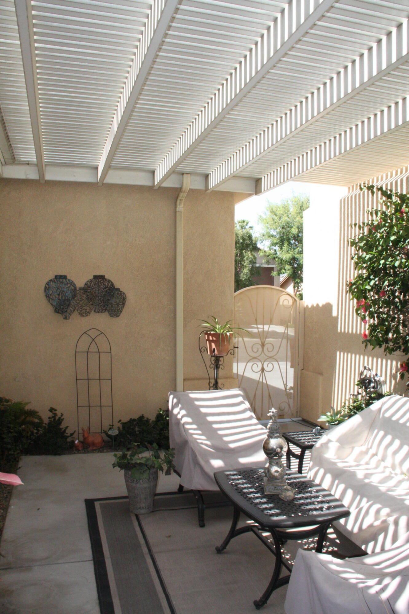 49758 Lewis Road Indio, CA 92201 - Photo 38 of 47 a view of a patio with table and chairs with wooden floor and fence