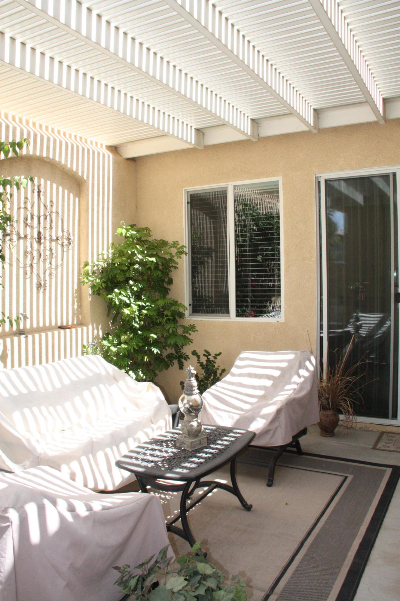 49758 Lewis Road Indio, CA 92201 - Photo 40 of 47 a view of a patio with table and chairs with wooden floor and fence