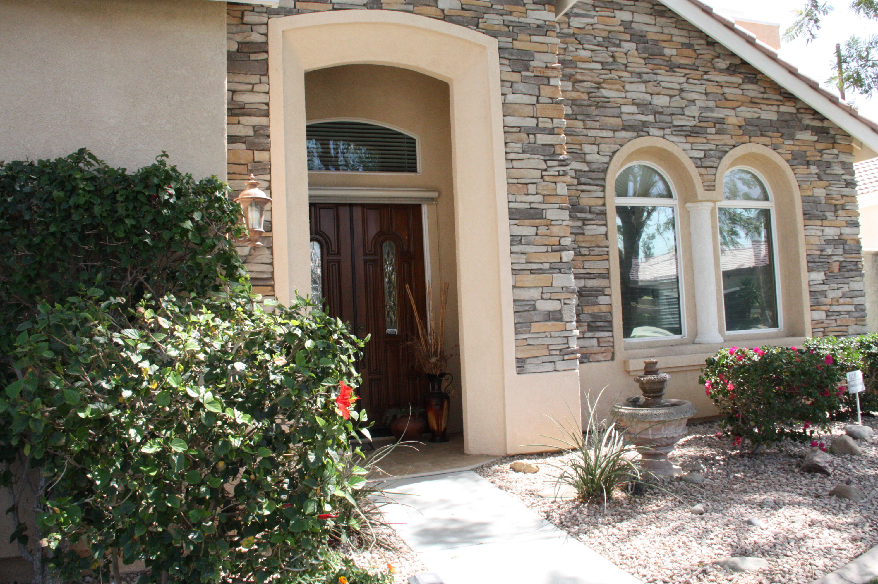 49758 Lewis Road Indio, CA 92201 - Photo 5 of 47 a front view of a house with a garden
