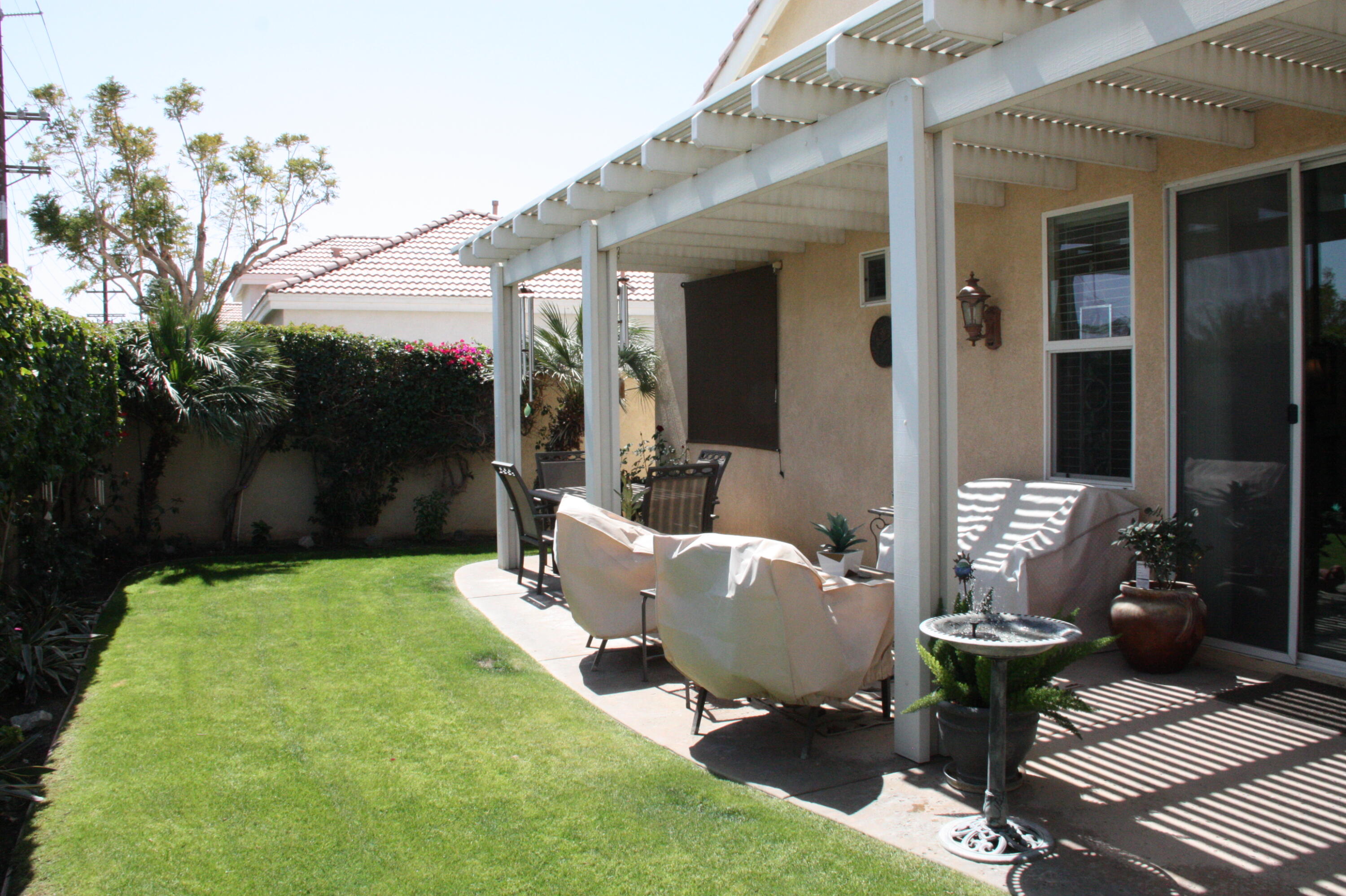 49758 Lewis Road Indio, CA 92201 - Photo 42 of 47 a view of a patio with table and chairs and potted plants