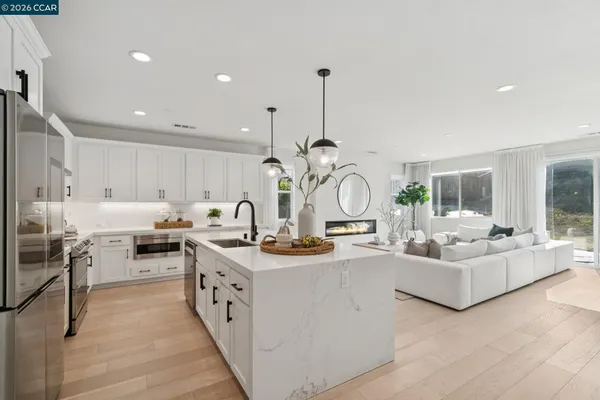 a very nice looking living room with stainless steel appliances granite countertop furniture and a view of living room