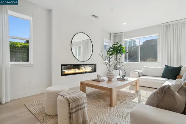 a living room with furniture a window and a potted plant