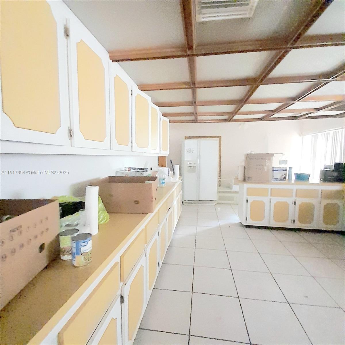 1830 Northeast 175th Street, Unit 1 North Miami Beach, FL 33162 - Photo 11 of 15 a kitchen with stainless steel appliances granite countertop a sink and white cabinets next to a window