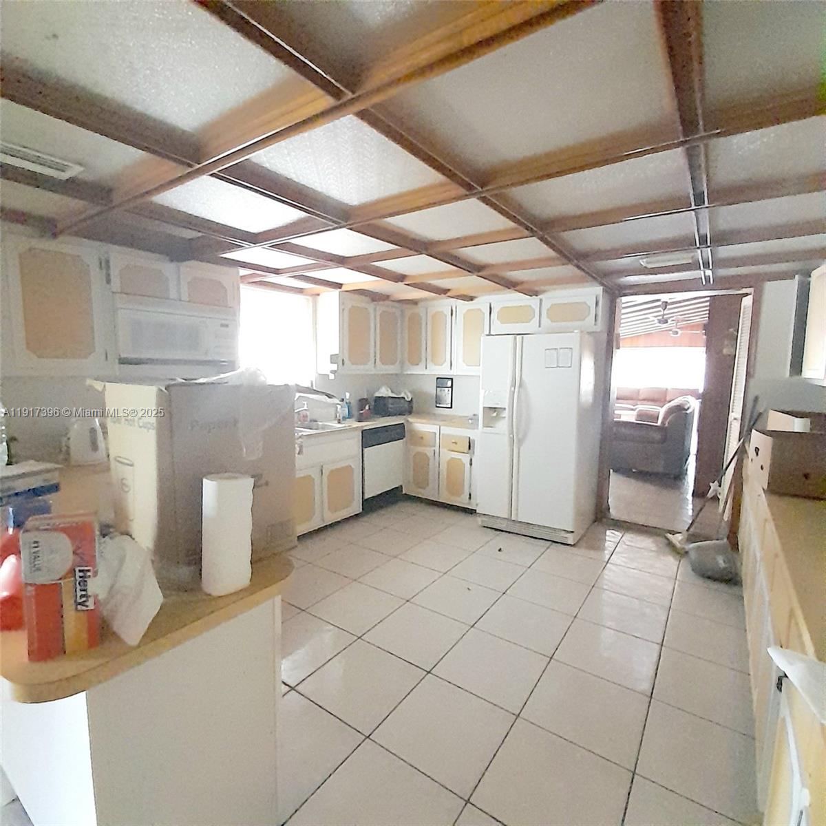 1830 Northeast 175th Street, Unit 1 North Miami Beach, FL 33162 - Photo 12 of 15 a kitchen with a sink and refrigerator