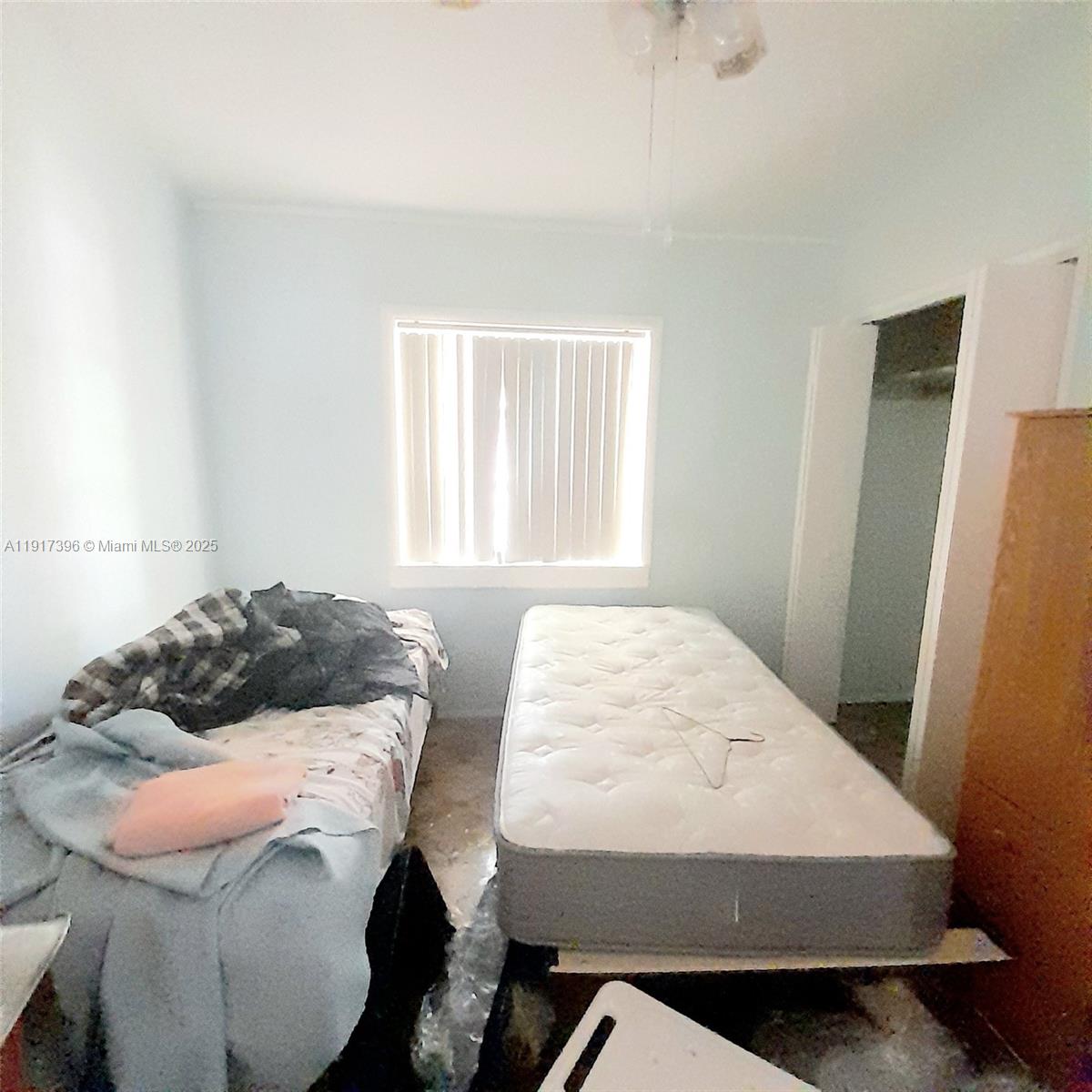 1830 Northeast 175th Street, Unit 1 North Miami Beach, FL 33162 - Photo 13 of 15 a bedroom with a bed and window