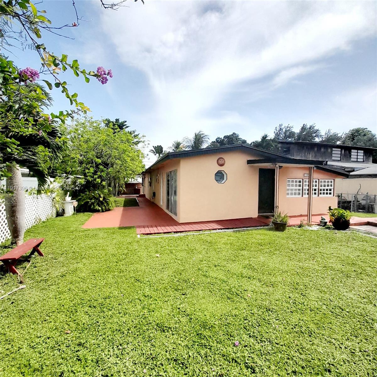 1830 Northeast 175th Street, Unit 1 North Miami Beach, FL 33162 - Photo 2 of 15 a view of backyard with barbeque grill and potted plants
