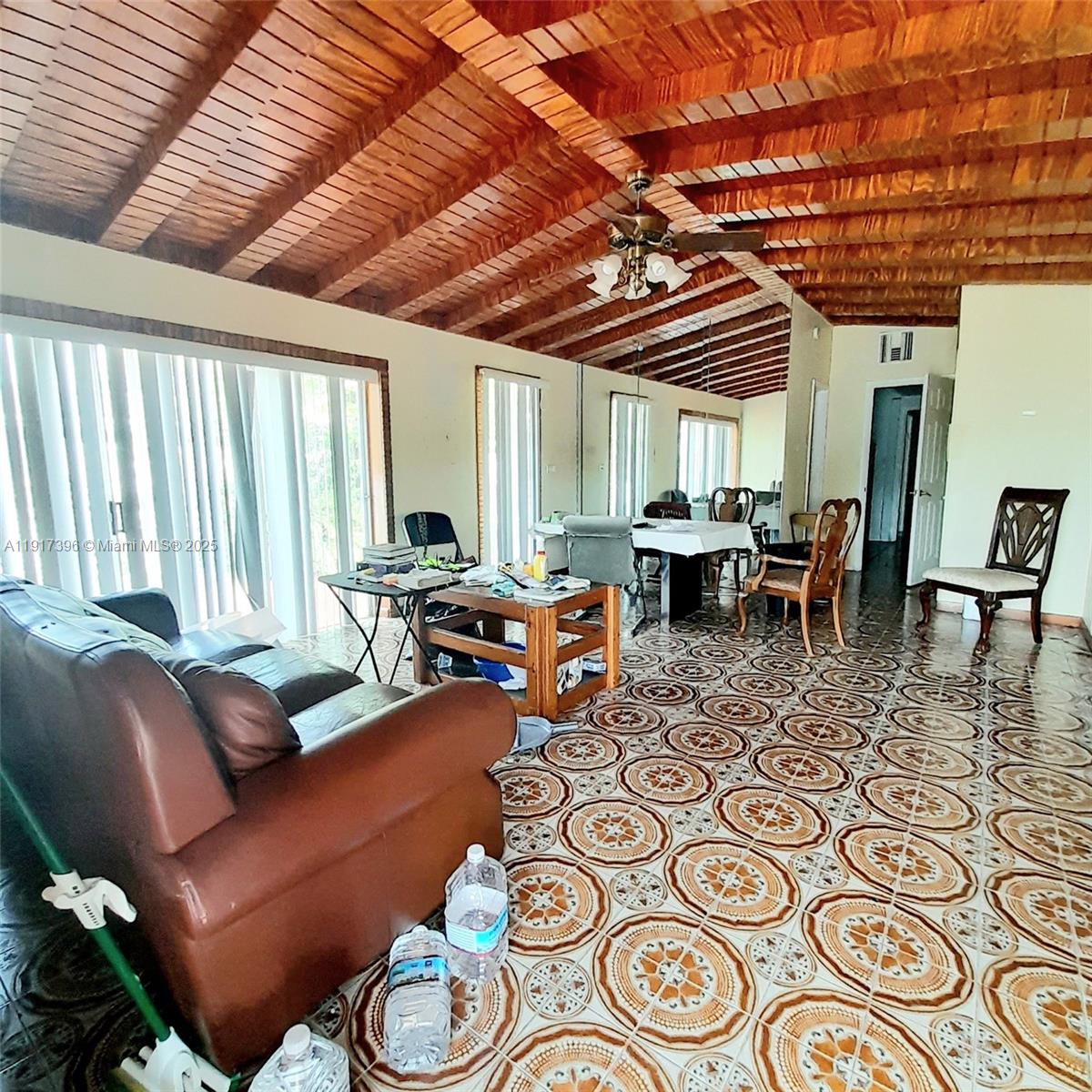 1830 Northeast 175th Street, Unit 1 North Miami Beach, FL 33162 - Photo 8 of 15 a living room with furniture and a large window