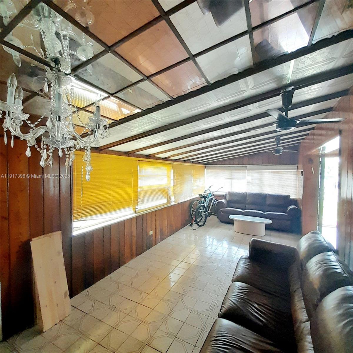 1830 Northeast 175th Street, Unit 1 North Miami Beach, FL 33162 - Photo 10 of 15 a living room with furniture and a potted plant