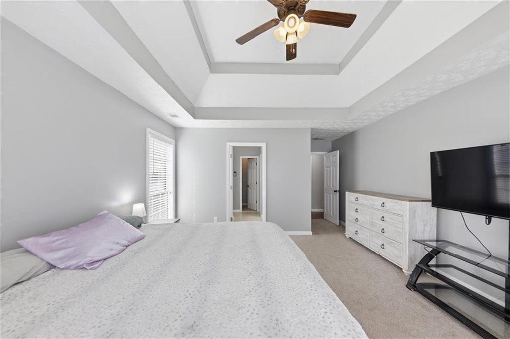 493 Youth Jersey Road Covington, GA 30014 - Photo 29 of 52 a bedroom with a bed and a flat screen tv