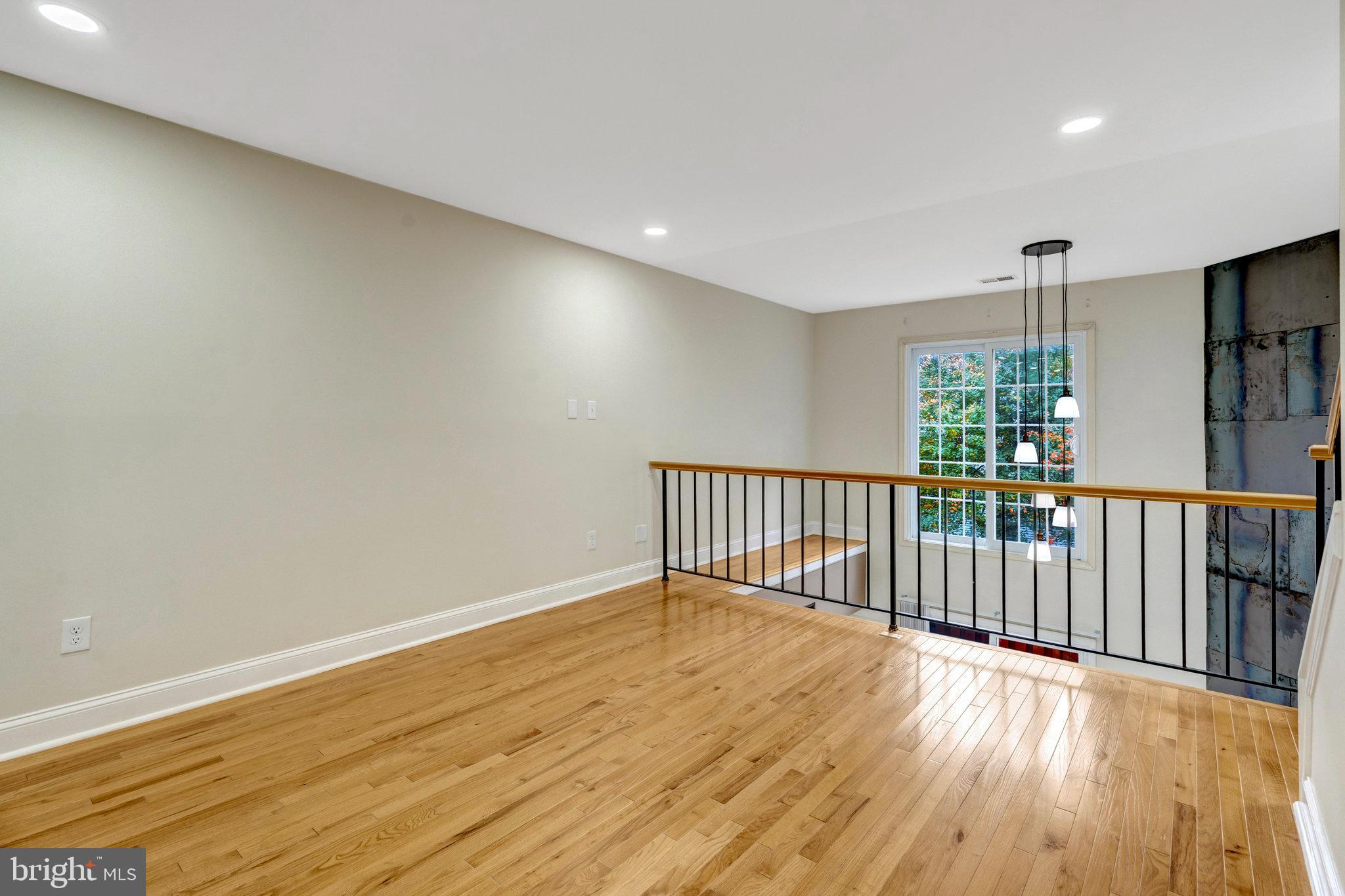 8482 Springfield Oaks Drive Springfield, VA 22153 - Photo 12 of 48 a view of a hallway with wooden floor and windows