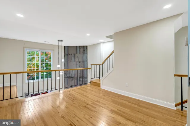 a view of a room with wooden floor