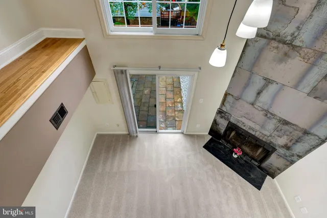 a view of a livingroom with wooden floor and a fireplace