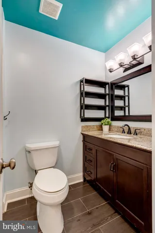 a bathroom with a toilet a sink and mirror