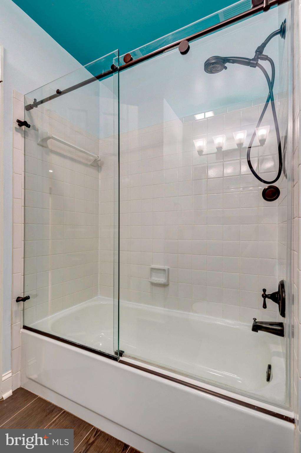 8482 Springfield Oaks Drive Springfield, VA 22153 - Photo 21 of 48 a bathroom that has a glass shower door