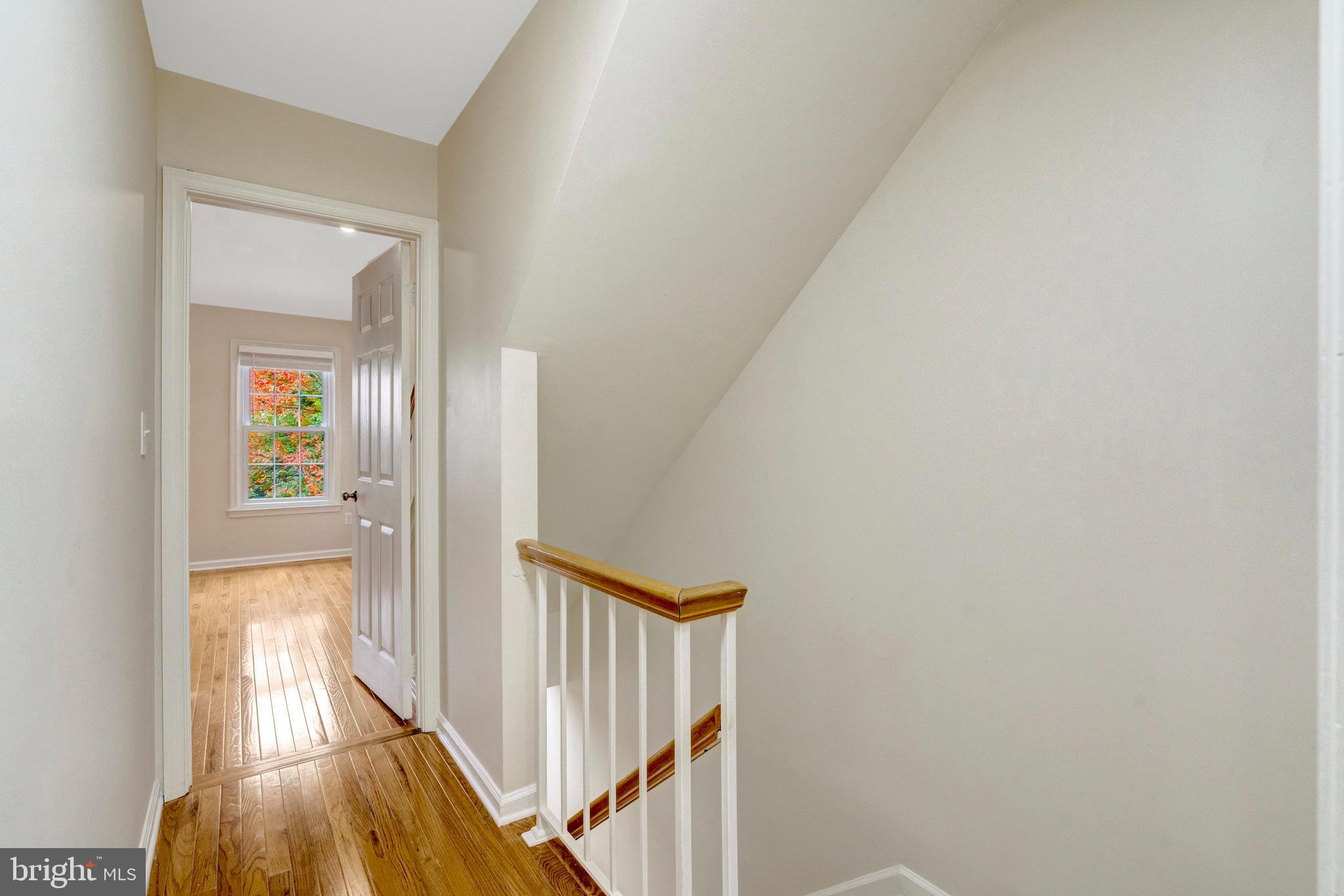 8482 Springfield Oaks Drive Springfield, VA 22153 - Photo 22 of 48 a view of a hallway with wooden floor and staircase
