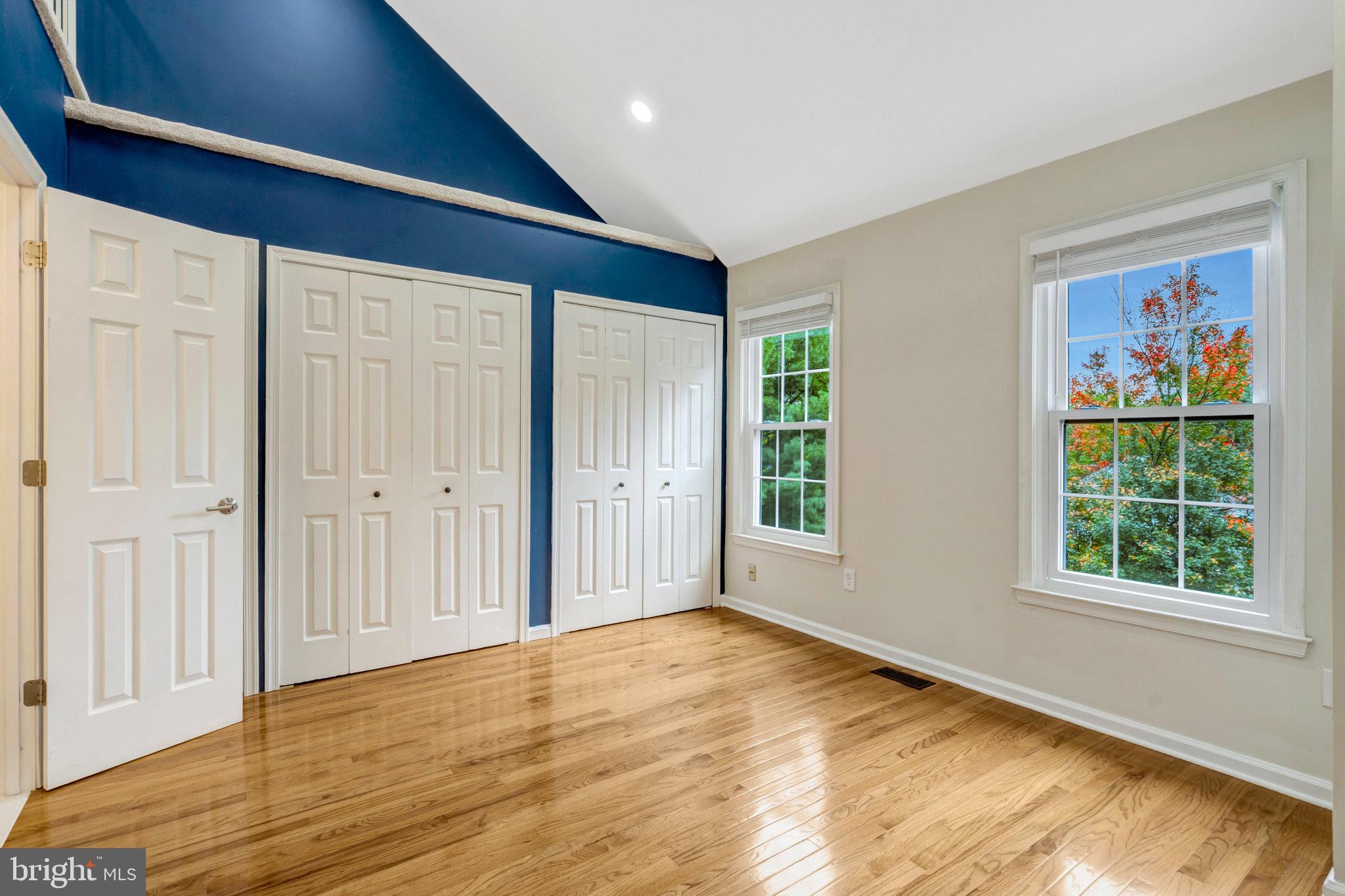 8482 Springfield Oaks Drive Springfield, VA 22153 - Photo 23 of 48 a view of an empty room with wooden floor and a window