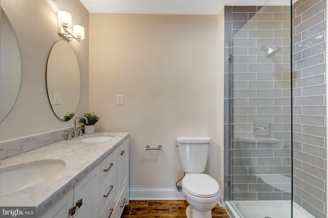 a bathroom with a sink a toilet and a mirror