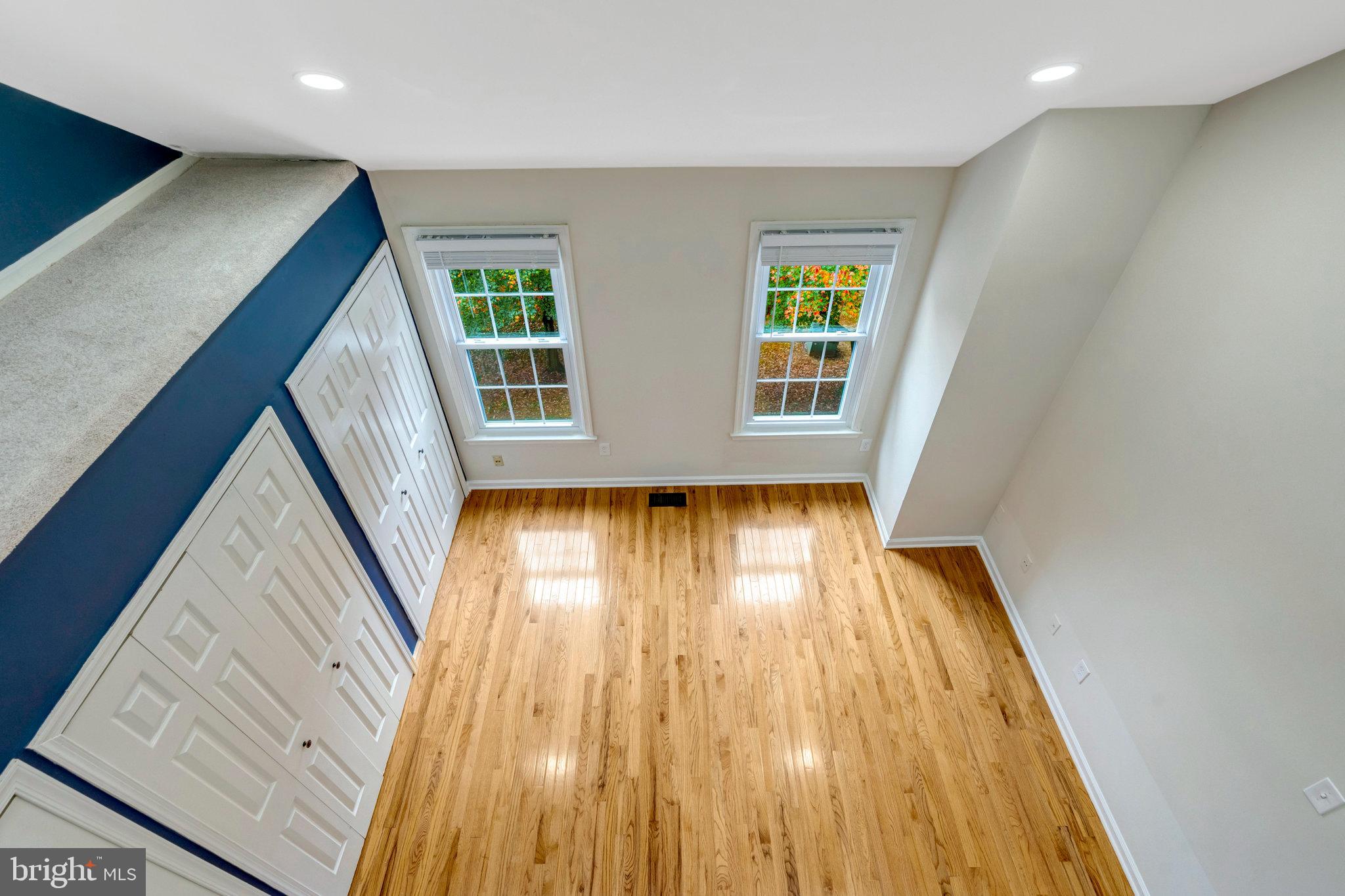 8482 Springfield Oaks Drive Springfield, VA 22153 - Photo 31 of 48 wooden floor in an empty room with a window
