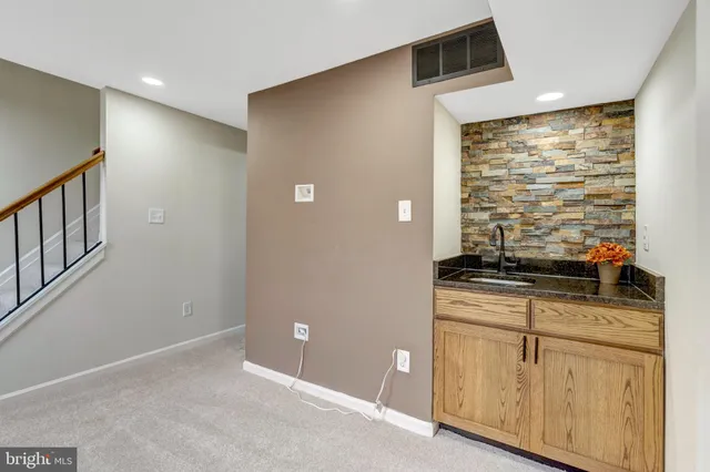 a kitchen with granite countertop a stove and a refrigerator