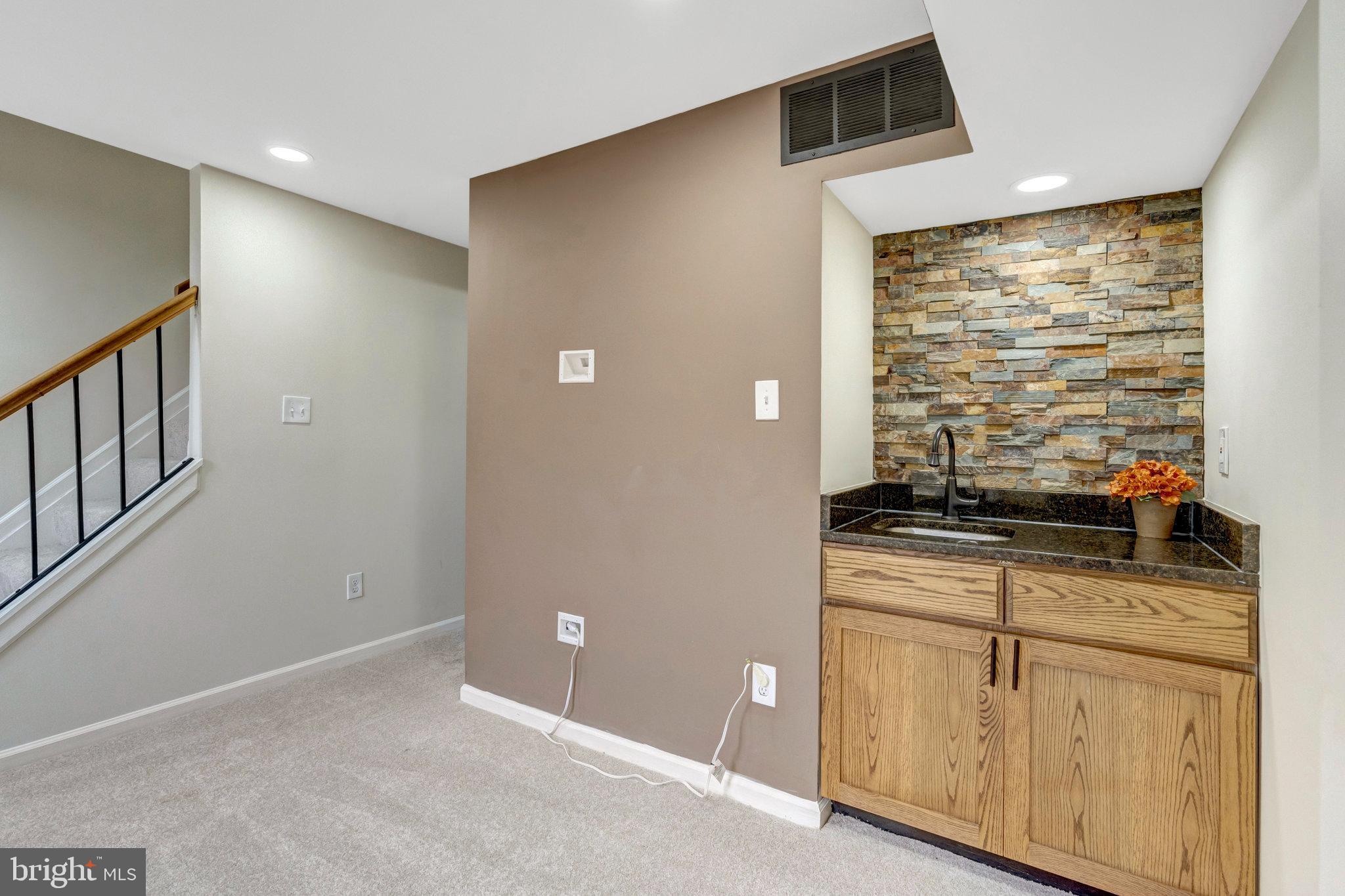 8482 Springfield Oaks Drive Springfield, VA 22153 - Photo 37 of 48 a kitchen with granite countertop a stove and a refrigerator