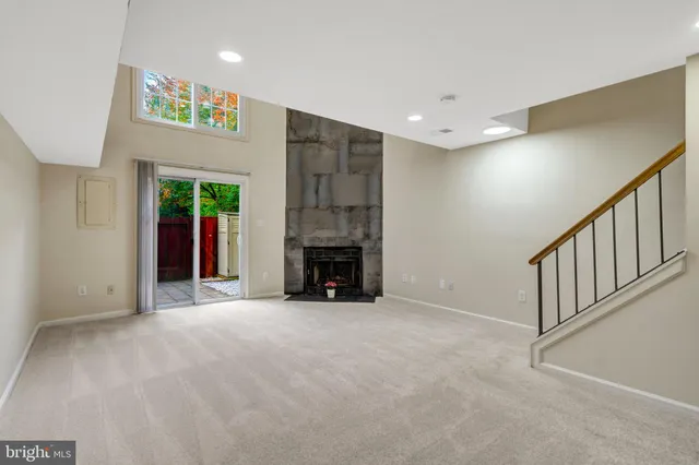 a view of an empty room with a fireplace
