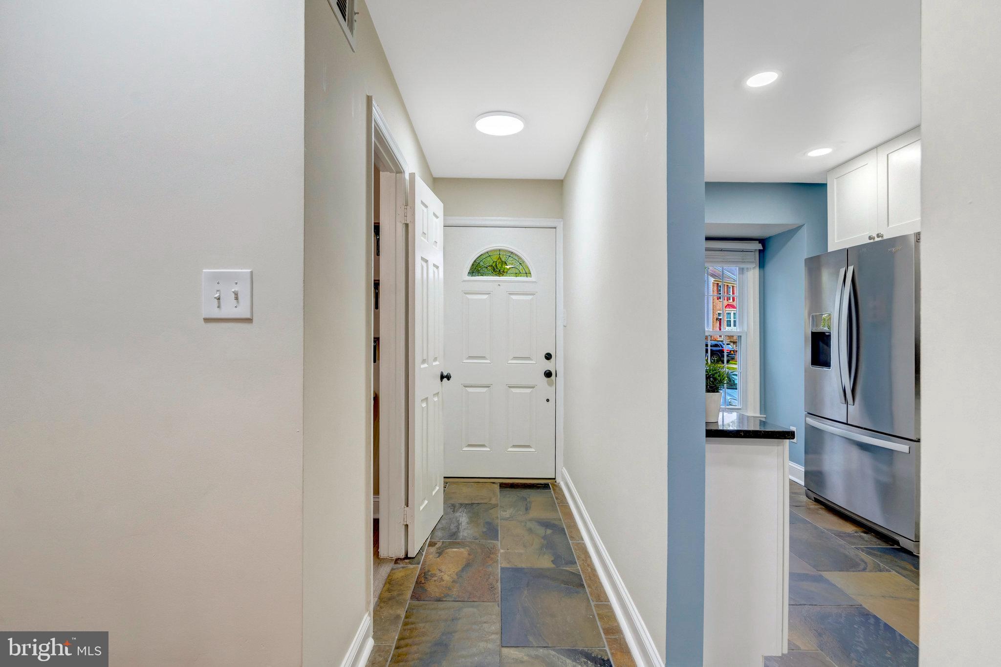 8482 Springfield Oaks Drive Springfield, VA 22153 - Photo 4 of 48 a view of a hallway with wooden cabinets