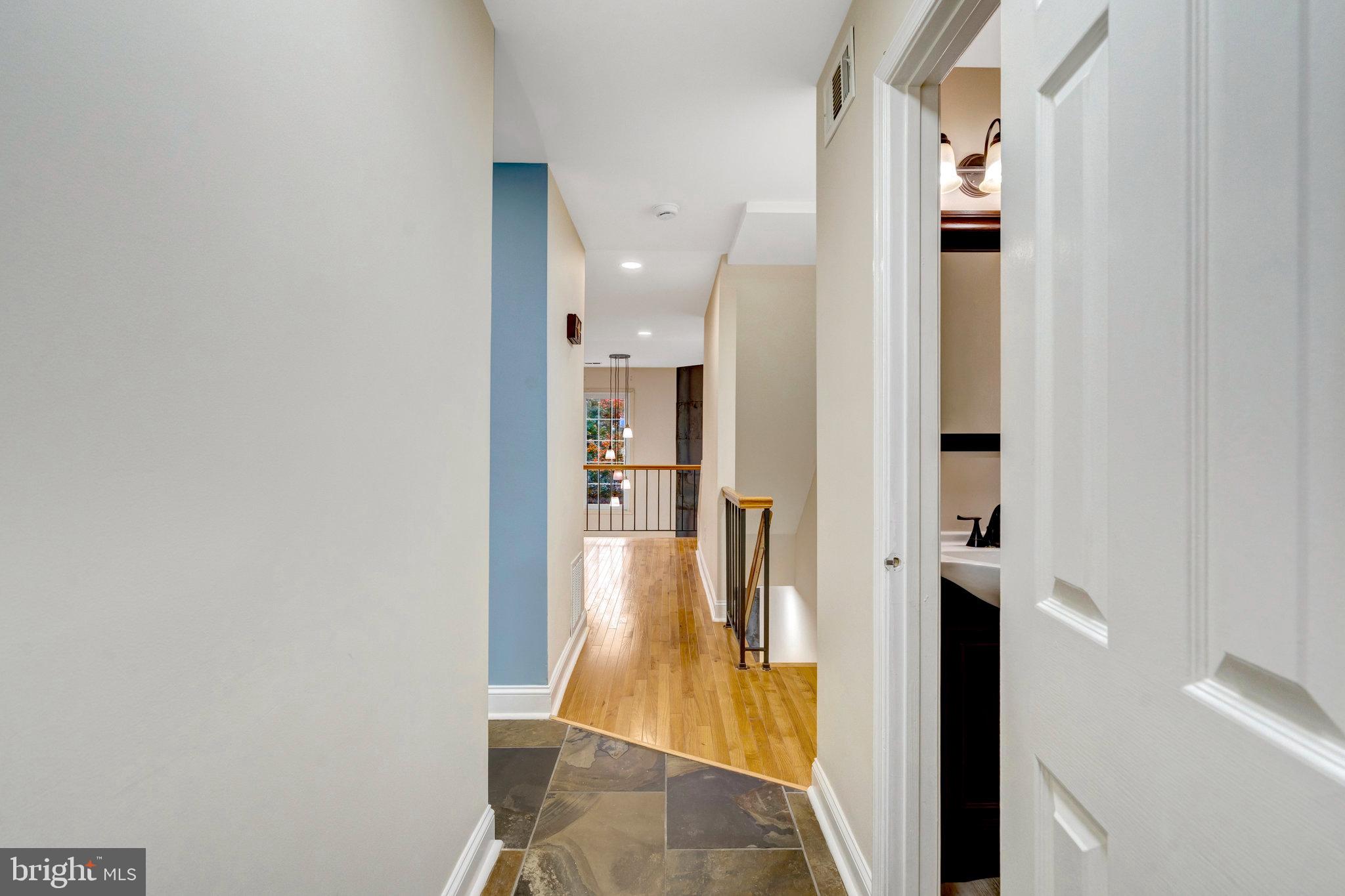 8482 Springfield Oaks Drive Springfield, VA 22153 - Photo 5 of 48 a view of a hallway with wooden floor and a bathroom
