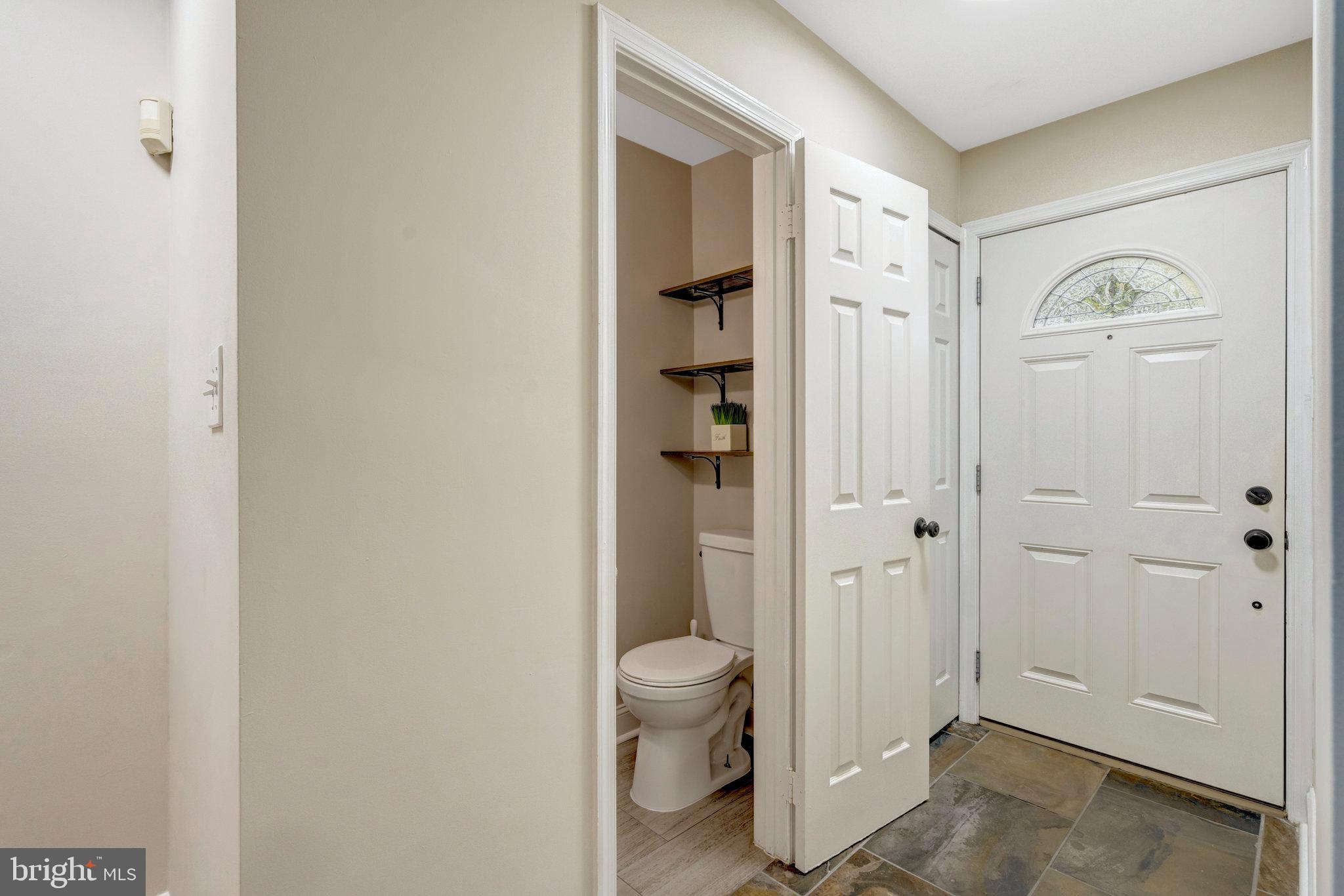 8482 Springfield Oaks Drive Springfield, VA 22153 - Photo 6 of 48 a bathroom with a granite countertop sink a toilet and shower