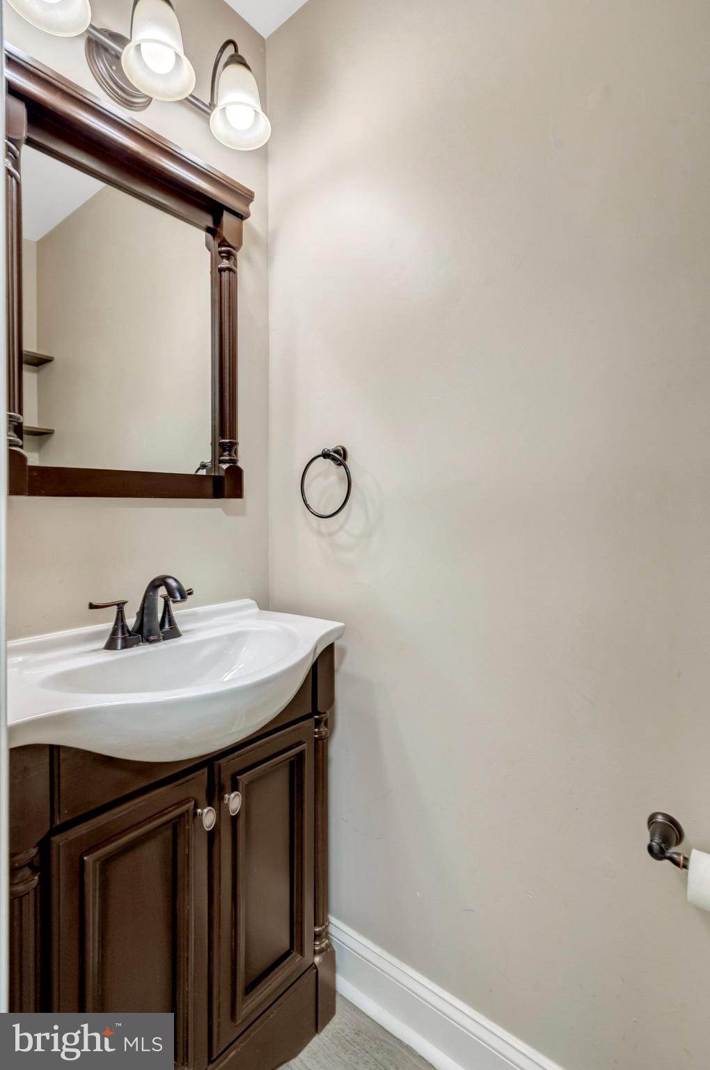 8482 Springfield Oaks Drive Springfield, VA 22153 - Photo 7 of 48 a bathroom with a sink a mirror and vanity