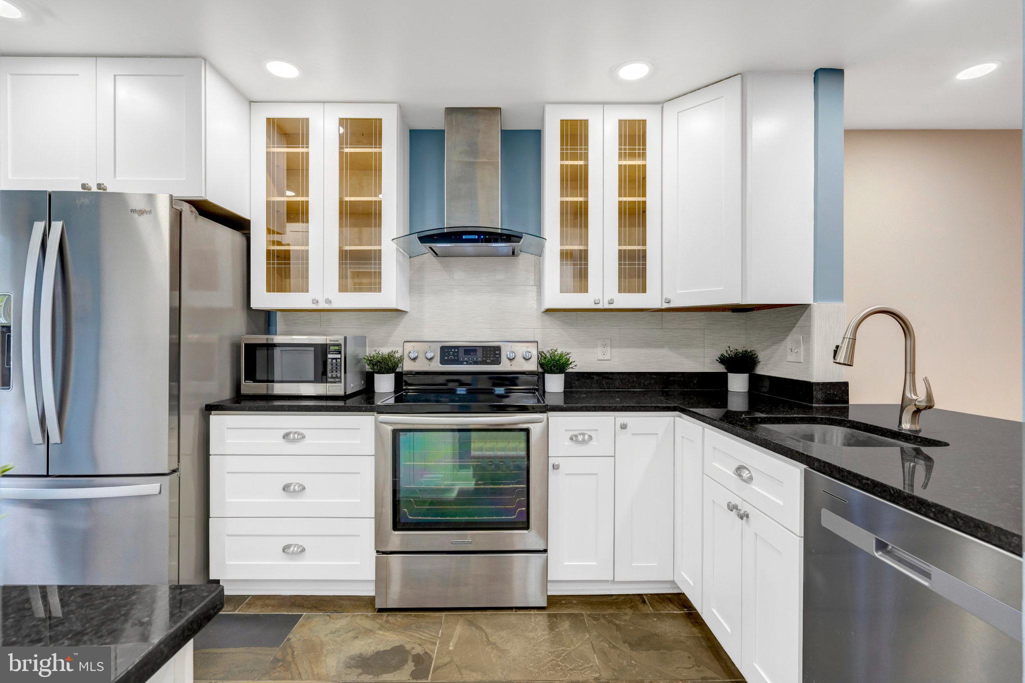 8482 Springfield Oaks Drive Springfield, VA 22153 - Photo 8 of 48 a kitchen with stainless steel appliances granite countertop a stove a sink and a refrigerator
