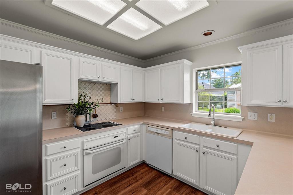 1962 Palmetto Road Benton, LA 71006 - Photo 12 of 40 The kitchen features white cabinetry, light-colored countertops, and stainless steel appliances