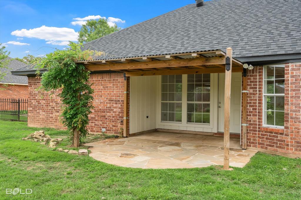 1962 Palmetto Road Benton, LA 71006 - Photo 26 of 40 This property features a covered patio with a flagstone surface, offering an inviting outdoor living space