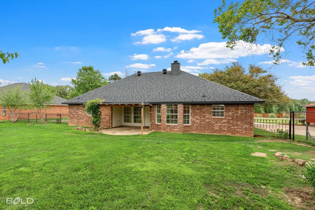 1962 Palmetto Road Benton, LA 71006 - Photo 27 of 40 The property features a brick exterior with a dark shingle roof and multiple windows