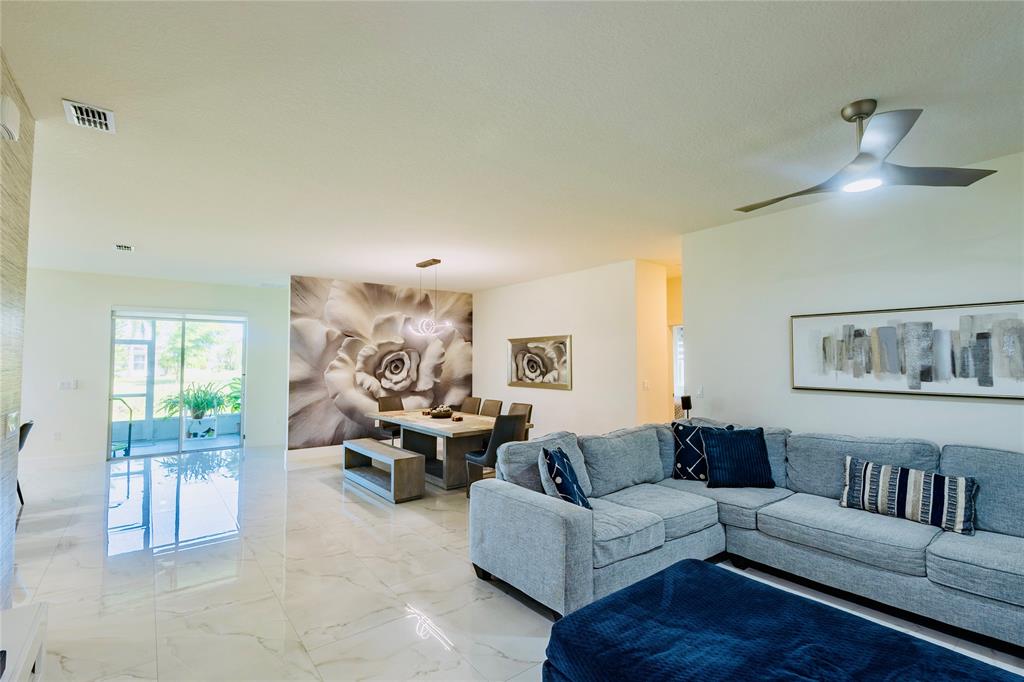 2149 Southwest Susset Lane Port St. Lucie, FL 34953 - Photo 14 of 47 a living room with furniture and a painting on the wall