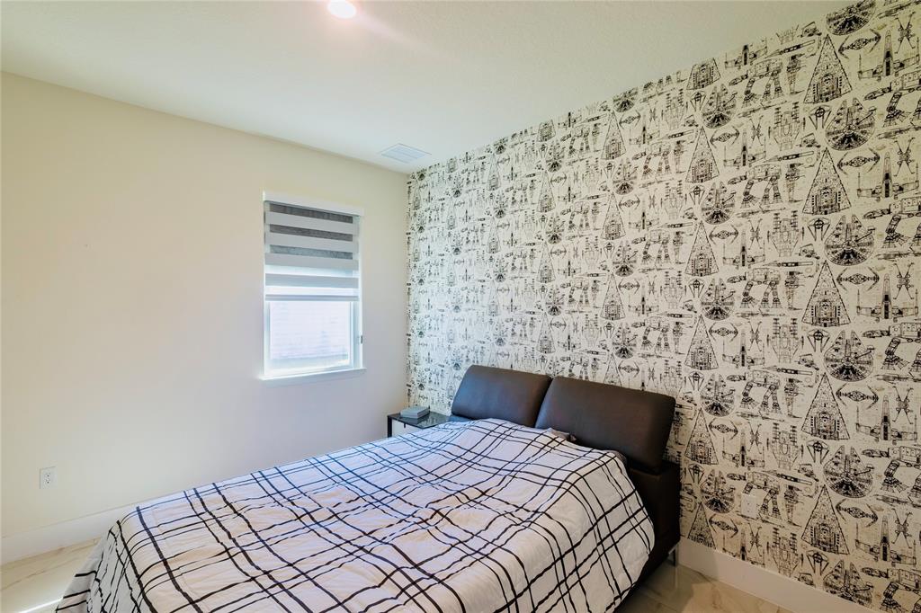 2149 Southwest Susset Lane Port St. Lucie, FL 34953 - Photo 18 of 47 a bedroom with a bed and a window