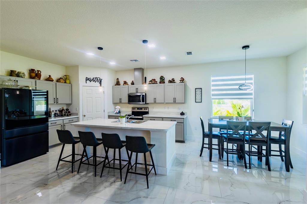 2149 Southwest Susset Lane Port St. Lucie, FL 34953 - Photo 26 of 47 a view of a dining room with furniture