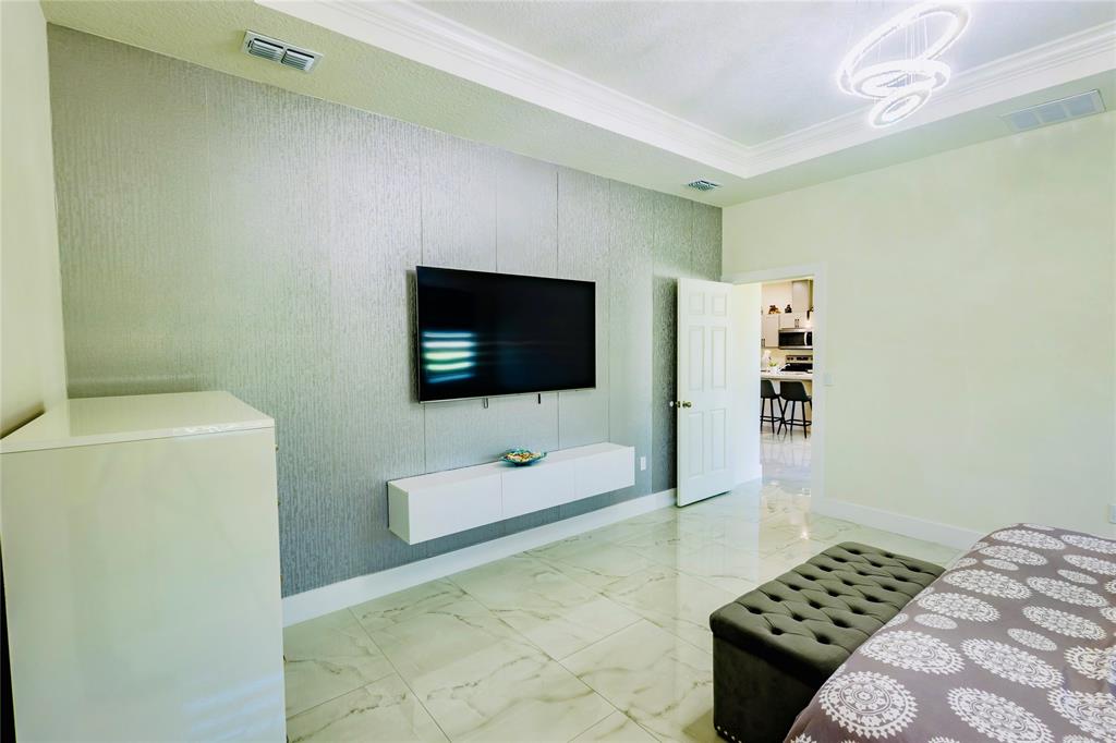 2149 Southwest Susset Lane Port St. Lucie, FL 34953 - Photo 30 of 47 a living room with a couch and a flat screen tv