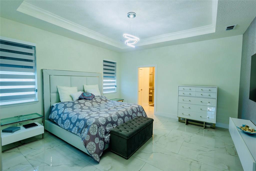 2149 Southwest Susset Lane Port St. Lucie, FL 34953 - Photo 31 of 47 a bedroom with a bed and a window