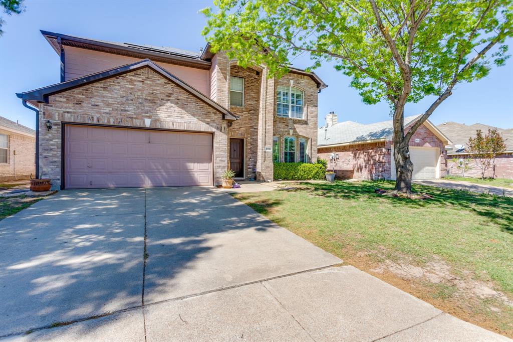 4816 Sleepy Ridge Circle Fort Worth, TX 76133 - Photo 3 of 36 Traditional-style home featuring an attached garage, driveway, and a front lawn
