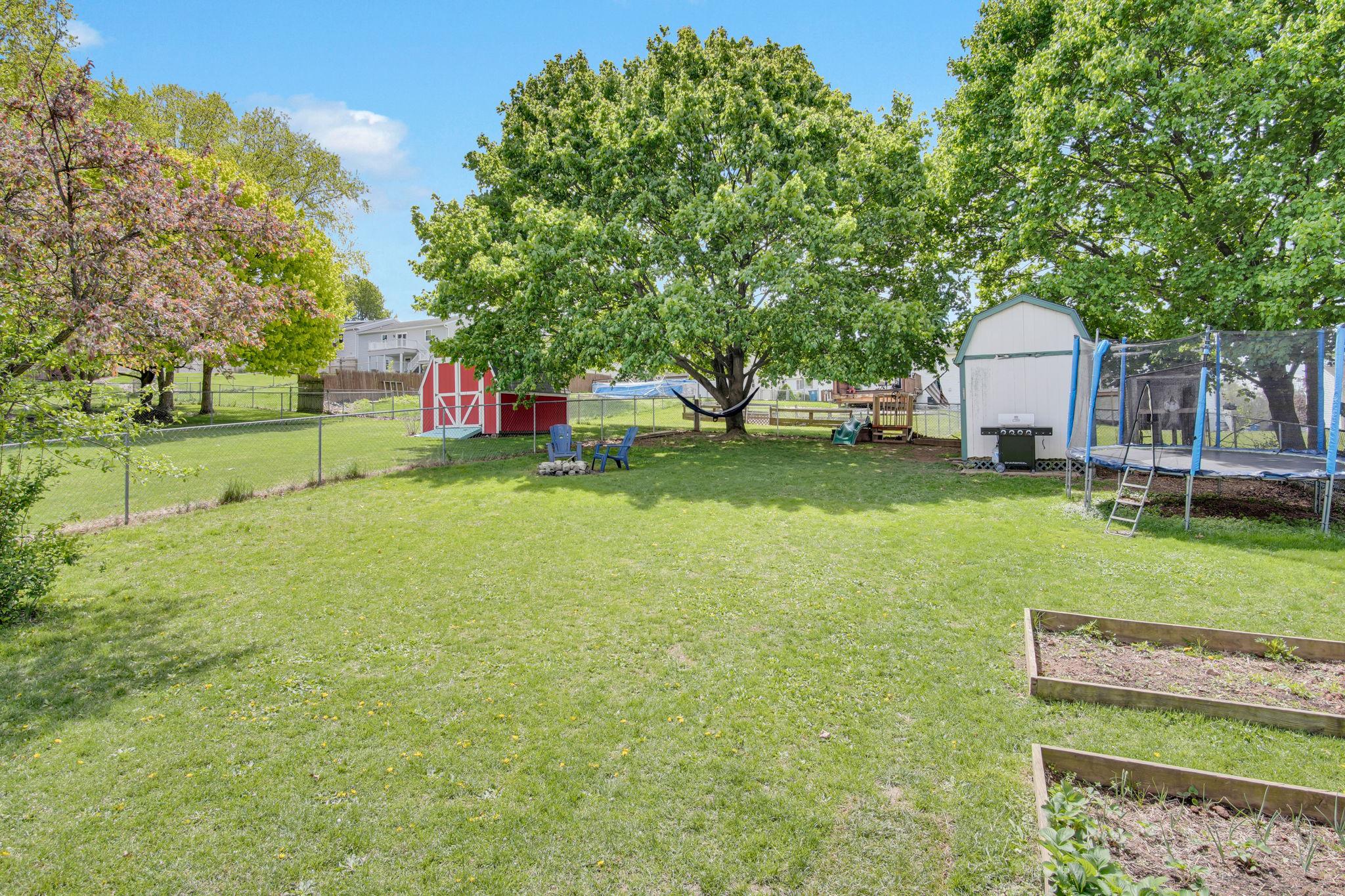 12 Furman Road Dillsburg, PA 17019 - Photo 31 of 33 Spacious backyard with vibrant greenery.