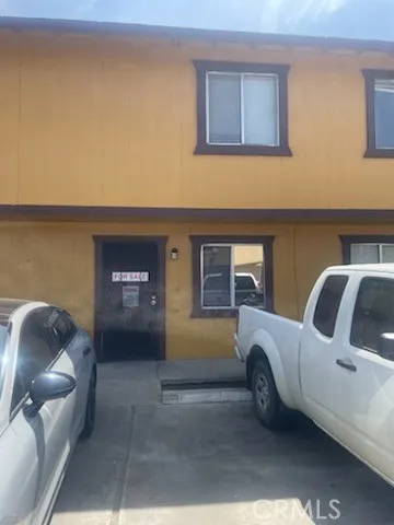 a backyard of a house with table and chairs