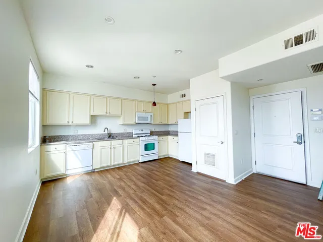 a kitchen with stainless steel appliances a refrigerator and a stove top oven