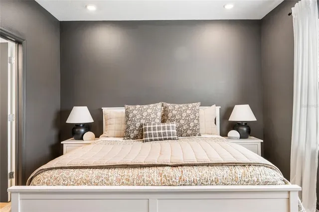 a bed sitting in a bedroom next to a window