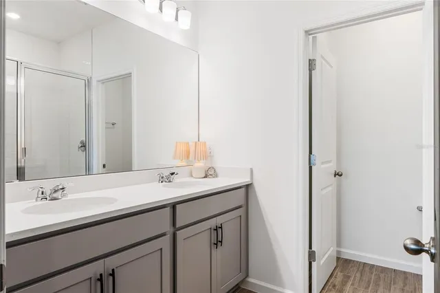 a bathroom with a double vanity sink and mirror